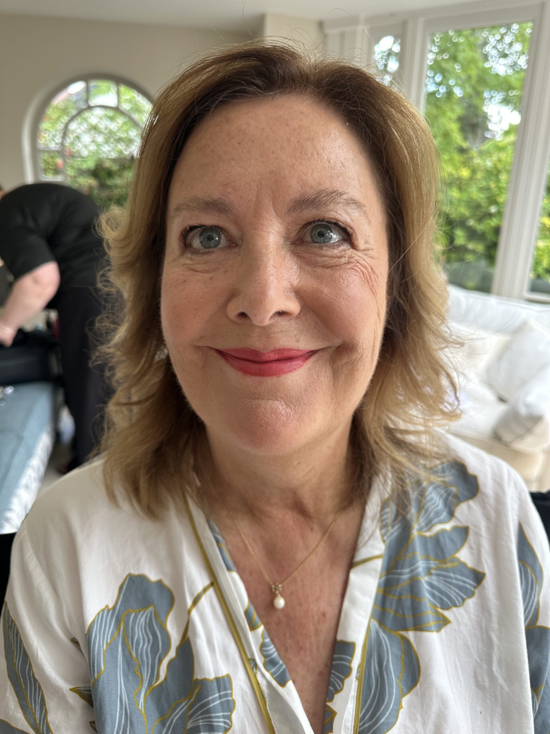 Woman with softly shaded eyes, fresh blush and warm rose lipstick by Mel England